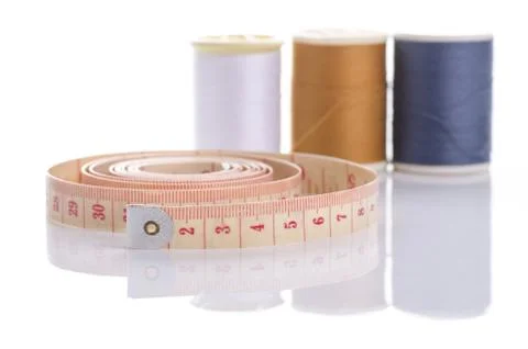 Measuring tape and rolls of thread, equipment needed for tailoring Stock Photos