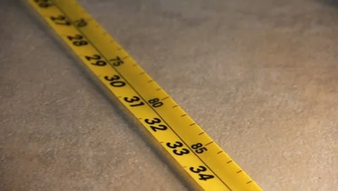 Measuring Tape being rolled up Stock Footage 7727641