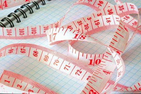 Measuring tape on a notebook close-up 스톡 사진