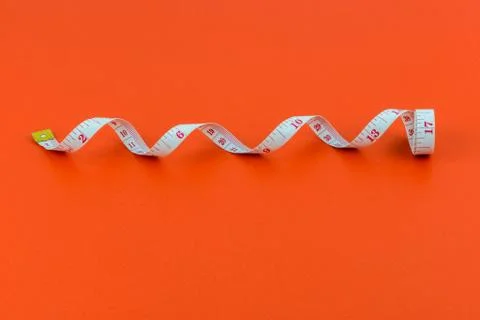 Measuring tape on red background Fotos de archivo