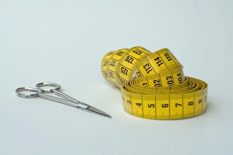 Measuring tape with scissors Stock Photos