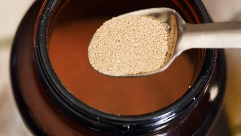 Measuring a Teaspoon of Active Dry Yeast Stock Footage 129552785