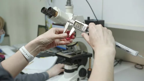 Measuring thickness of thermal washer in laboratory Stock Footage 231219382