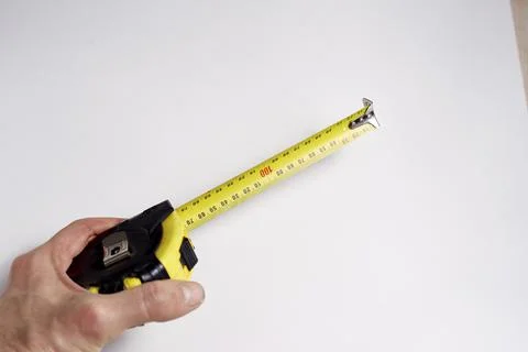 Measuring tool in hand on a white background is needed for construction Stock Photos
