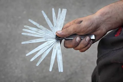 Measuring tool in mechanic hands Stock Photos