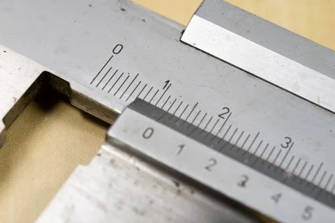 Measuring tools in the workshop. Caliper for locksmith work on a wooden table Stock Photos
