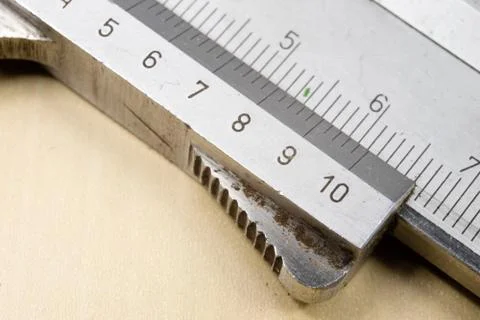 Measuring tools in the workshop. Caliper for locksmith work on a wooden table Stock Photos