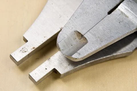 Measuring tools in the workshop. Caliper for locksmith work on a wooden table Stock Photos
