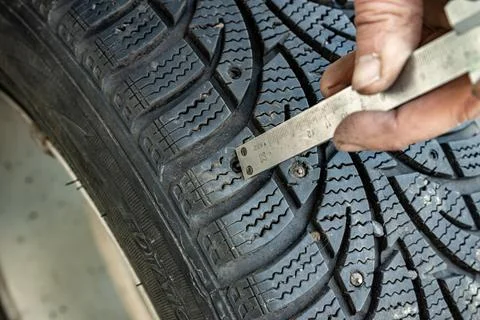 Measuring tread depth and stud hole depth for repair assessment Stock Photos
