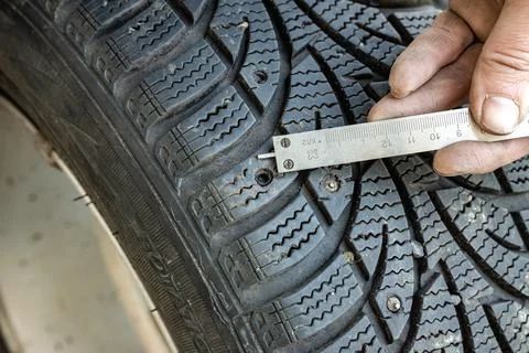 Measuring tread depth and stud hole depth for repair assessment Stock Photos