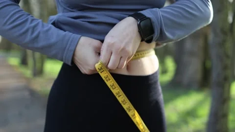 Measuring waist after workout Video stock 334575735