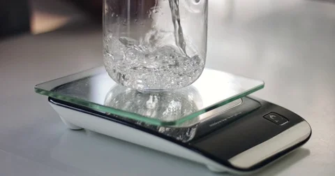 Measuring water for cooking Stock Footage 82739753