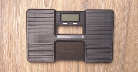 Measuring weight with funny socks Stock Footage 115119781