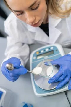 Measuring white powder using a precision laboratory scale at an analytical Stock Photos