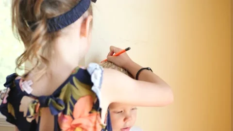 Measuring a young boy's height next to wall Stock-Footage 143197322