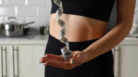 Measuring your Waist Size for Achieving Fitness Goals in a Home Kitchen Stock Footage 311550542