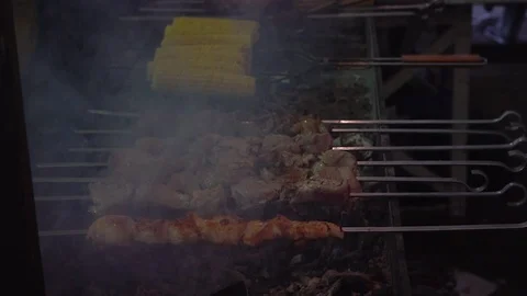 Meat and corn on grill. Meat fried on mangal. Cooking pork meat on hot charcoal. Stock Footage 69943447