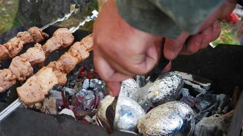 Meat and Potatoes Cooked on Fire Stock Footage 68097013