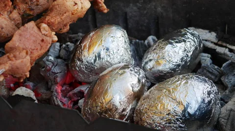 Meat and Potatoes Cooked on Fire Stock Footage 68098651