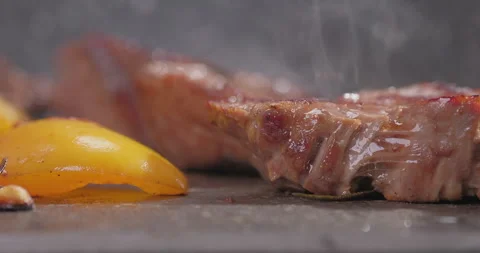 Meat and vegetable cooking on a frying pan. View from inside frying pan. Close Stock Footage 251869012