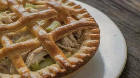 Meat and vegetable pie with a flaky crust on a plate Stock Photos