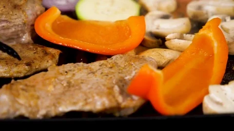 Meat and vegetables getting grilled Stock Footage 85380443