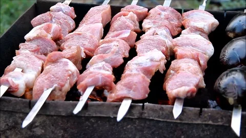 Meat and vegetables on skewers being prepared Stock Footage