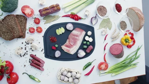 Meat and vegetables surrounded by fresh ingredients on table Stock Footage 232520881