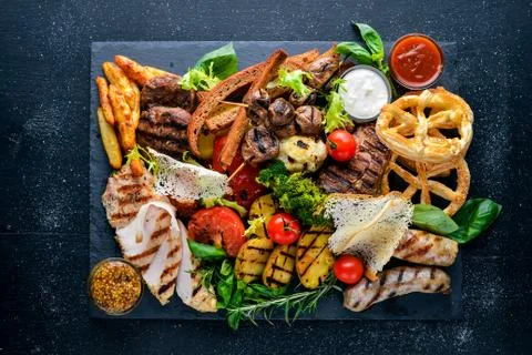 Meat assorted and cold appetizers. Ukrainian style. On a wooden background. T Stock Photos