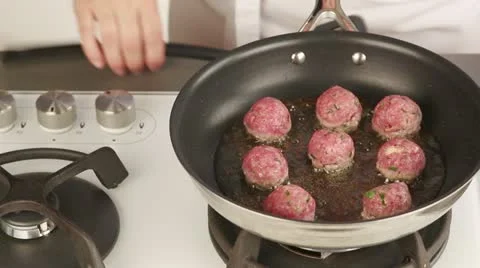 Meat balls being fried on all sides Video stock 24671850