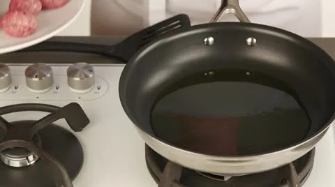 Meat balls being placed in a pan and fried Stock Footage 24671846