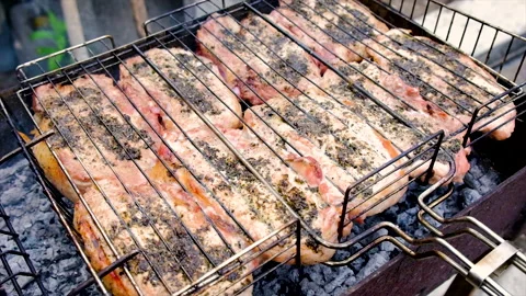 The meat is barbecued over a fire. Selective focus. Stock Footage 155390649
