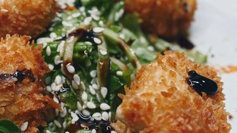 Meat in batter on a plate poured over sauce in 4k resolution Stock Footage 111429700