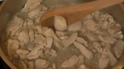 Meat beef cut into small pieces fried in a pan with smoke, close-up Stock Footage 128060169