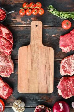 Meat beef steaks frame concept, with different steak cuts andempty chopping b Stock Photos