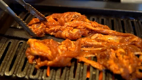 Meat being placed on a hot grill Stock Footage 96562381
