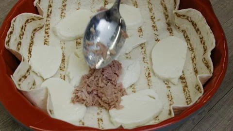Meat being placed on mozzarella slices over tortilla in a baking dish. Stock Footage 266420950