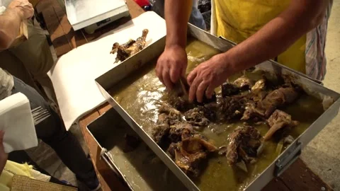 Meat being served by man with his bare hands at an Ikarian festival Stock Footage 144451538