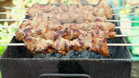 Meat being turned on a grill Stock Footage 49005518