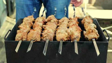 Meat being turned on a grill Stock Footage 49005665