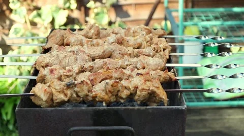 Meat being turned on a grill Stock Footage 49005904