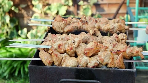 Meat being turned on a grill Stock Footage 49005983