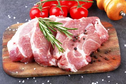 Meat on black surface Stock Photos