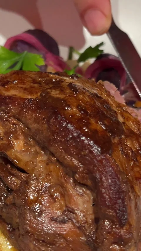 Meat on the bone savory baked lamb shank resting on a bed of creamy mashed Stock Footage 293861427