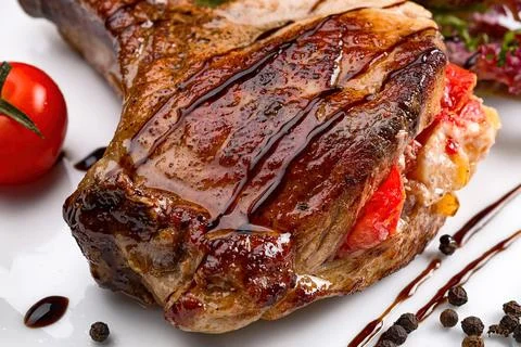 Meat on the bone with vegetables. Close up Stock Photos