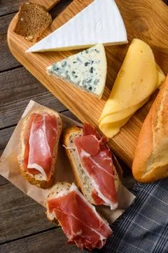 Meat, bread and various cheeses. Ingredients for dinner Stock Photos