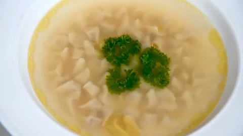 Meat broth with tiny dumplings. Asian cuisine. Video stock 112989921