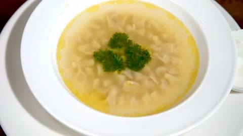 Meat broth with tiny dumplings. Asian cuisine. Exotic Food Video stock 112990561