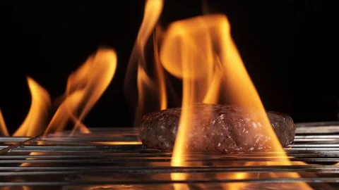 The meat for the burger is cooked on fire, close-up. Barbecue meat is grilled Stock Footage 125832468