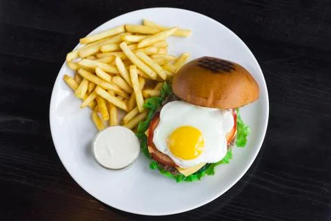 The Meat Burger with egg, sauce and fries Stock Photos